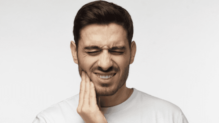 man holding jaw from tooth pain before an extraction